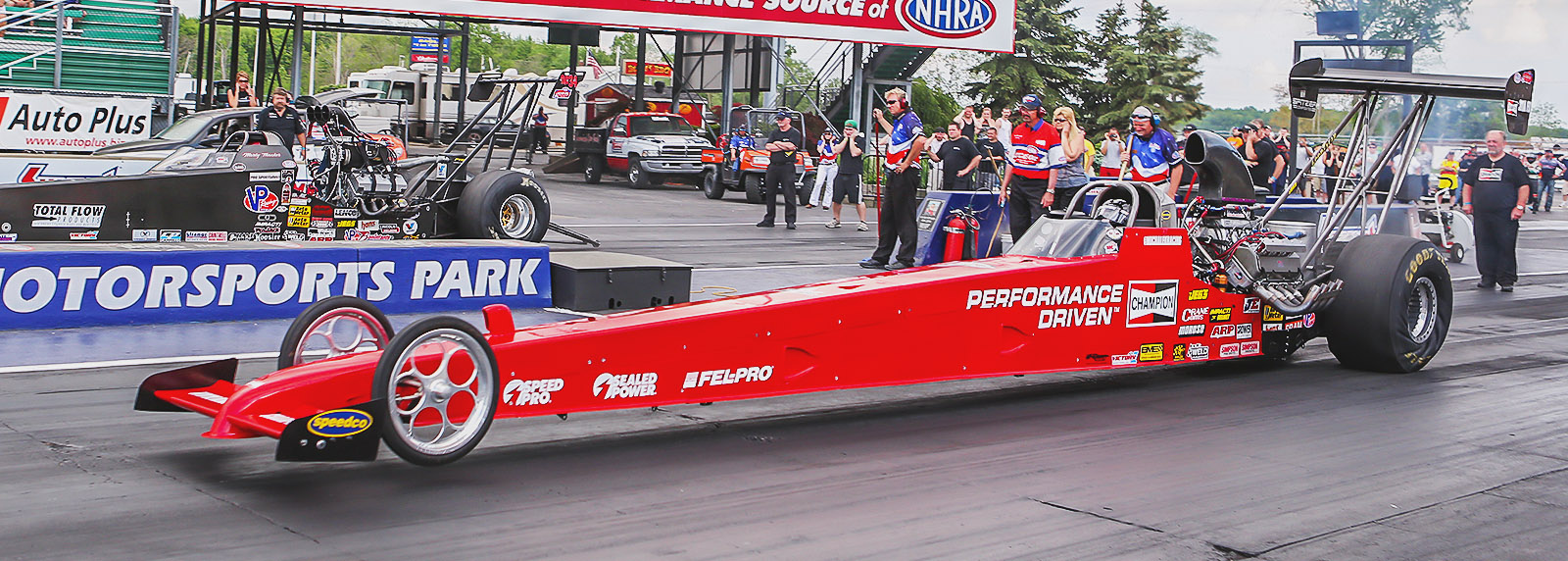 Kyle Michalek and Marty Thacker blast off the starting line, side-by-side with the Mickey Mart Rewards Cavalcade of Stars event trophy on the line.