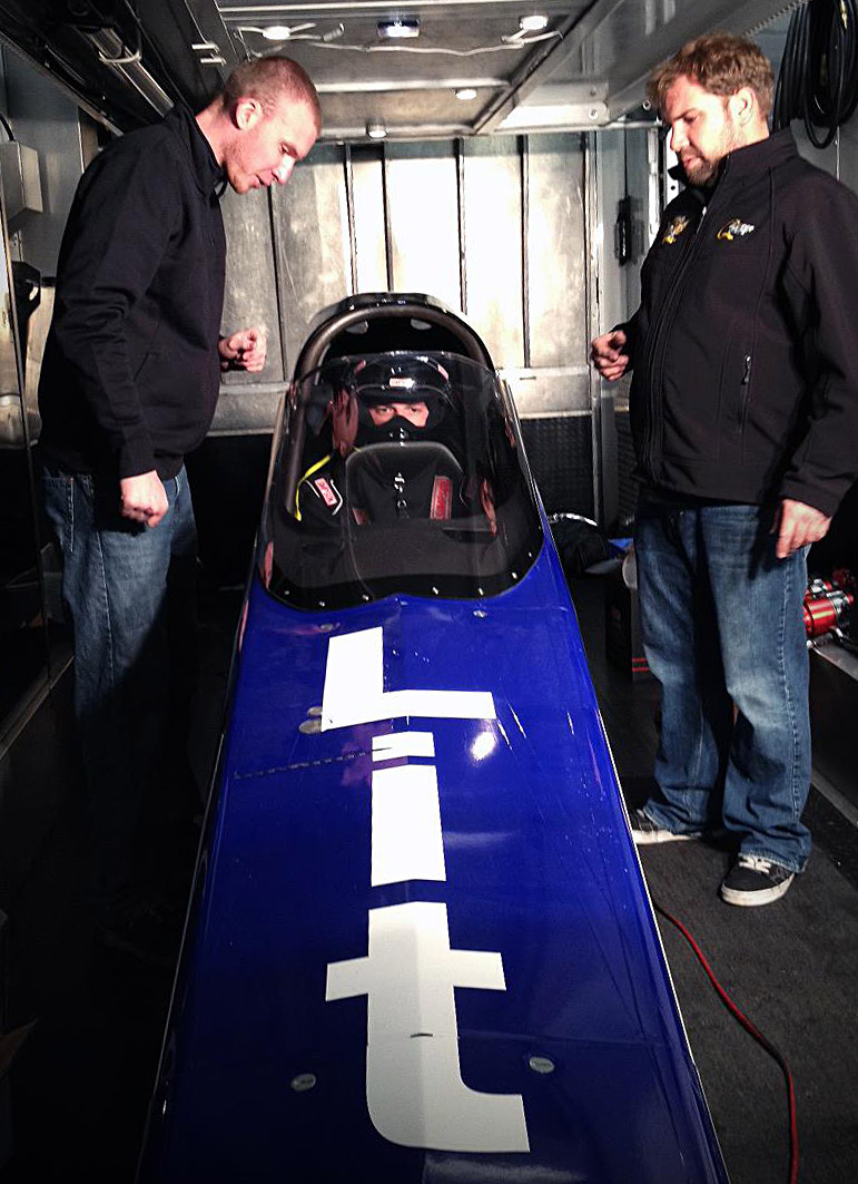 Michalek Brothers Racing driver Kyle Michalek and car owner Anthony Dicero walk Corey through the driving procedure of a 3,500 horsepower A/fuel dragster.