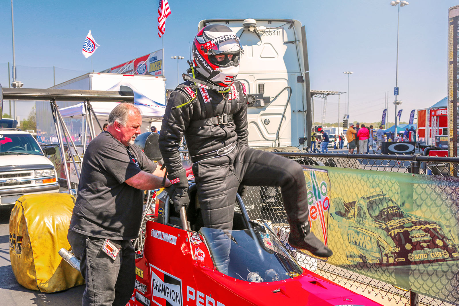 Corey Michalek climbs into the Champion Spark Plugs A/fuel dragster prior to the final round of qualifying at the 2014 NHRA Four Wide Nationals.
